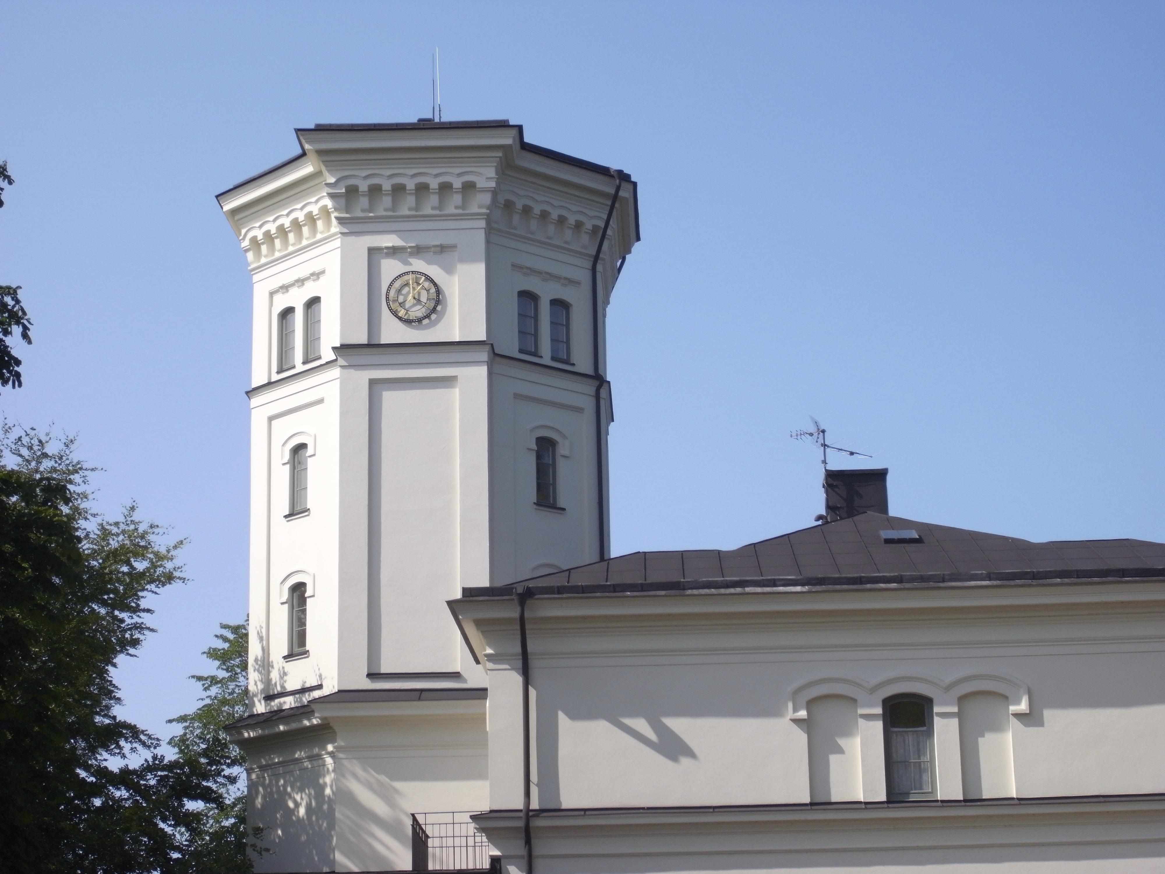 Vadstena klosterträdgårdar. Tornhuset. En vitputsad byggnad med ett åttakantigt torn.