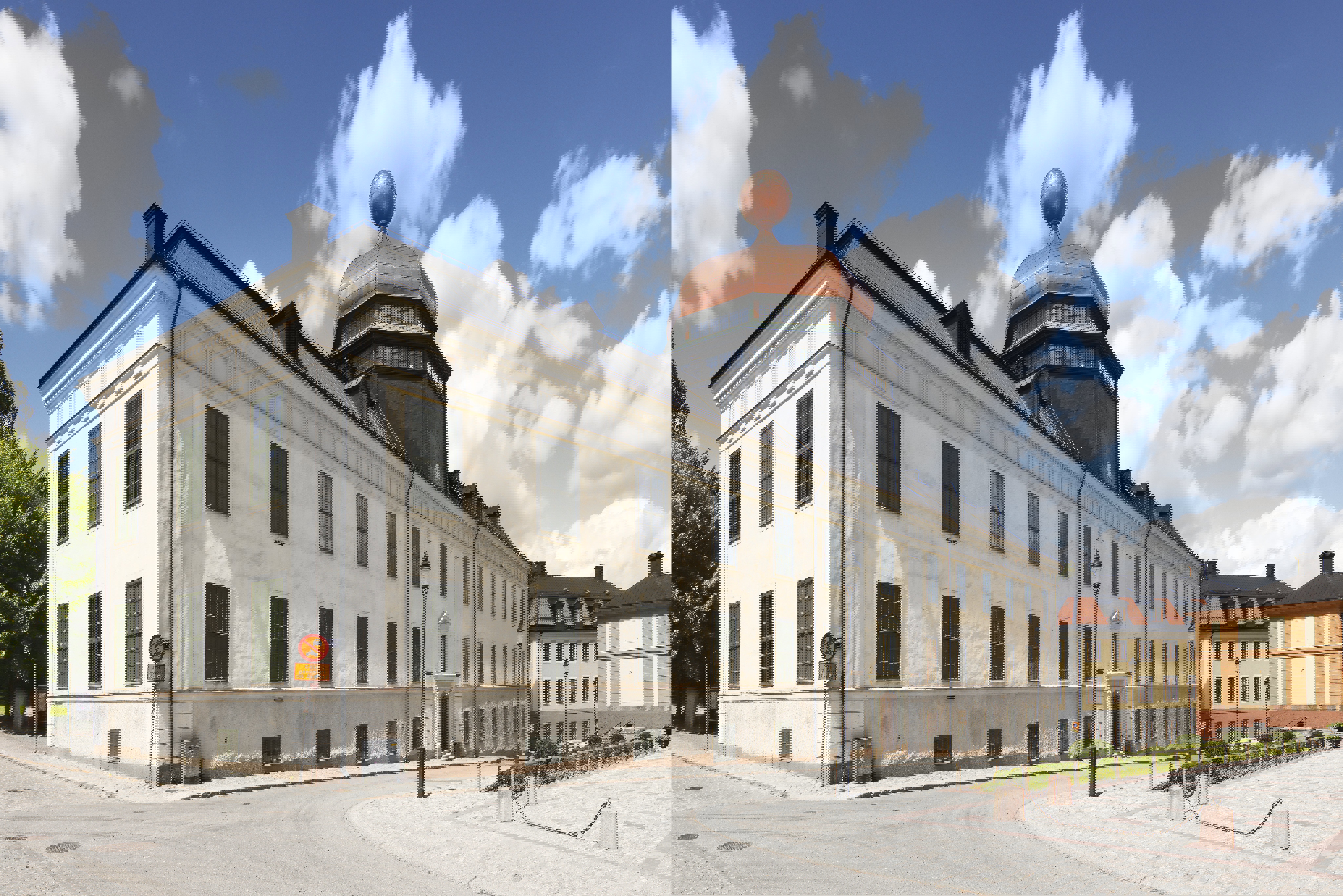 Gustavianum med närmiljö. Byggnaden har ny, gräddvit puts och tak-kupolens nya kopparplåt glänser röd.