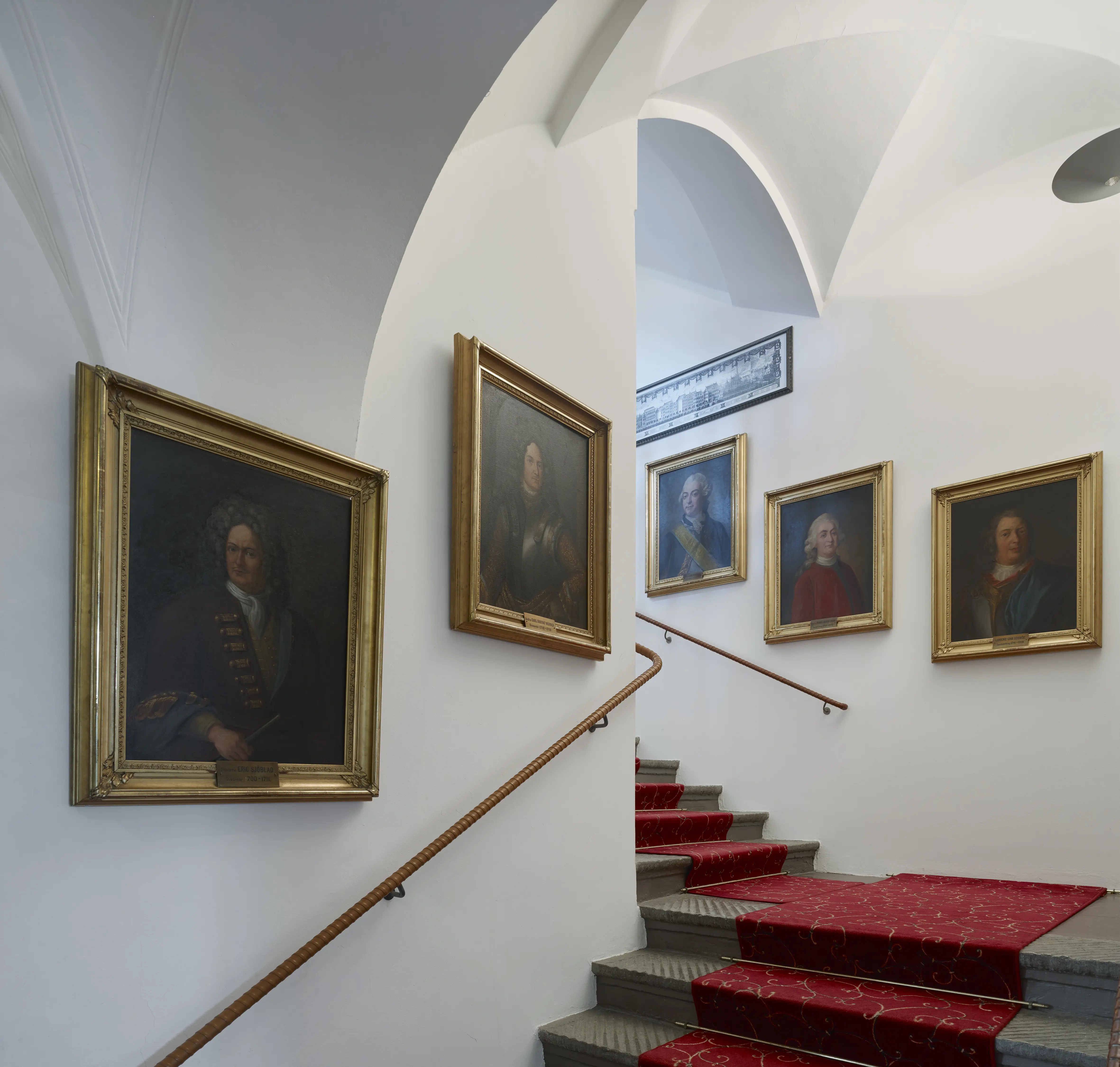 Interiör, residenset i Göteborg. Stentrappa med korsvalv. På väggarna hänger porträtt i förgyllda ramar.