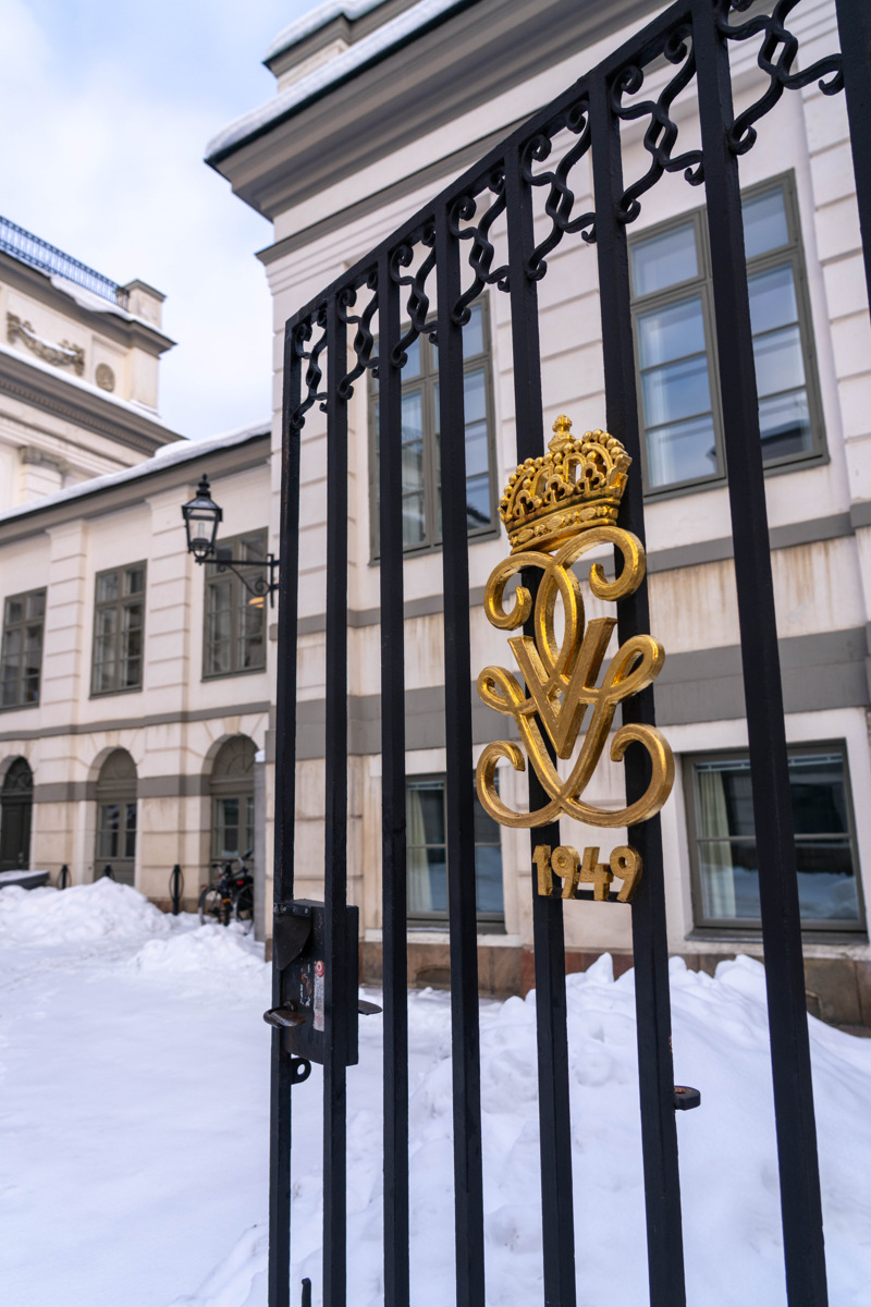 Bondeska palatset. Gjutjärns-grind med förgyllt kungligt monogram och årtalet nittonhundrafyrtionio. Vinter och snö.
