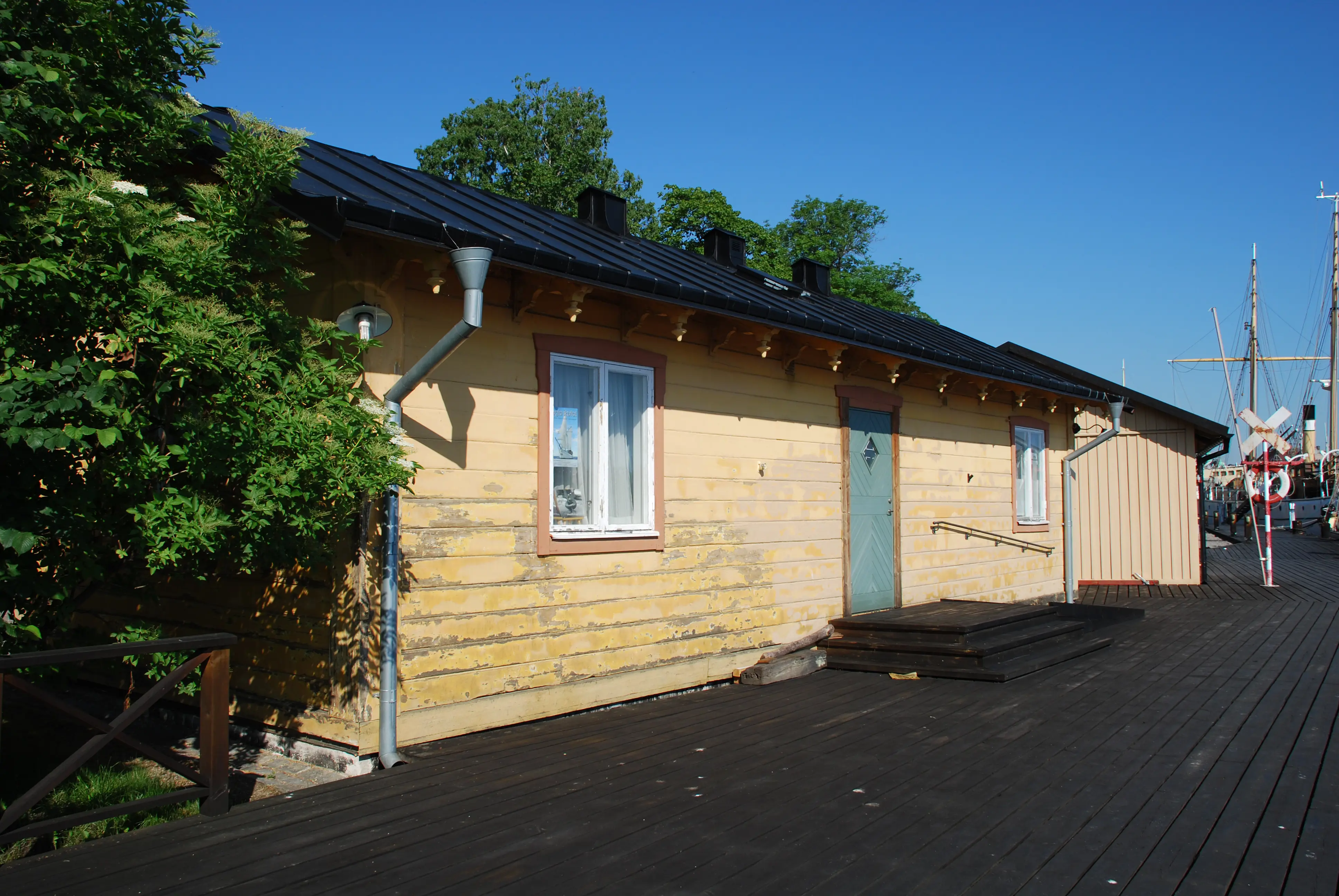 Kallbadets paviljong på Skeppsholmen. Den gulmålade träfasaden mot kajen.