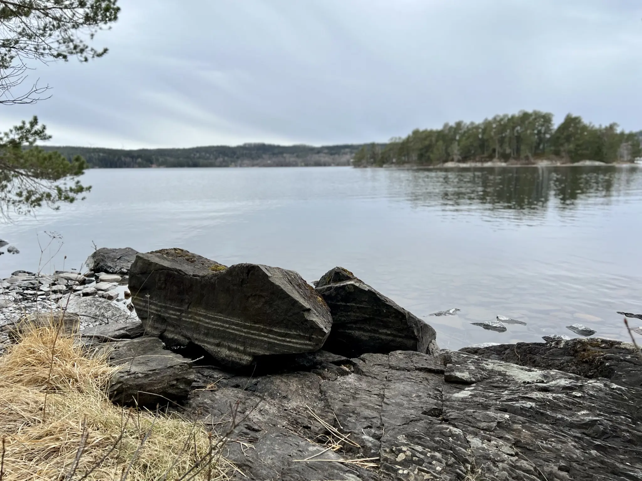 Högsbyn. Utsikt över sjön från den steniga stranden. Höst.