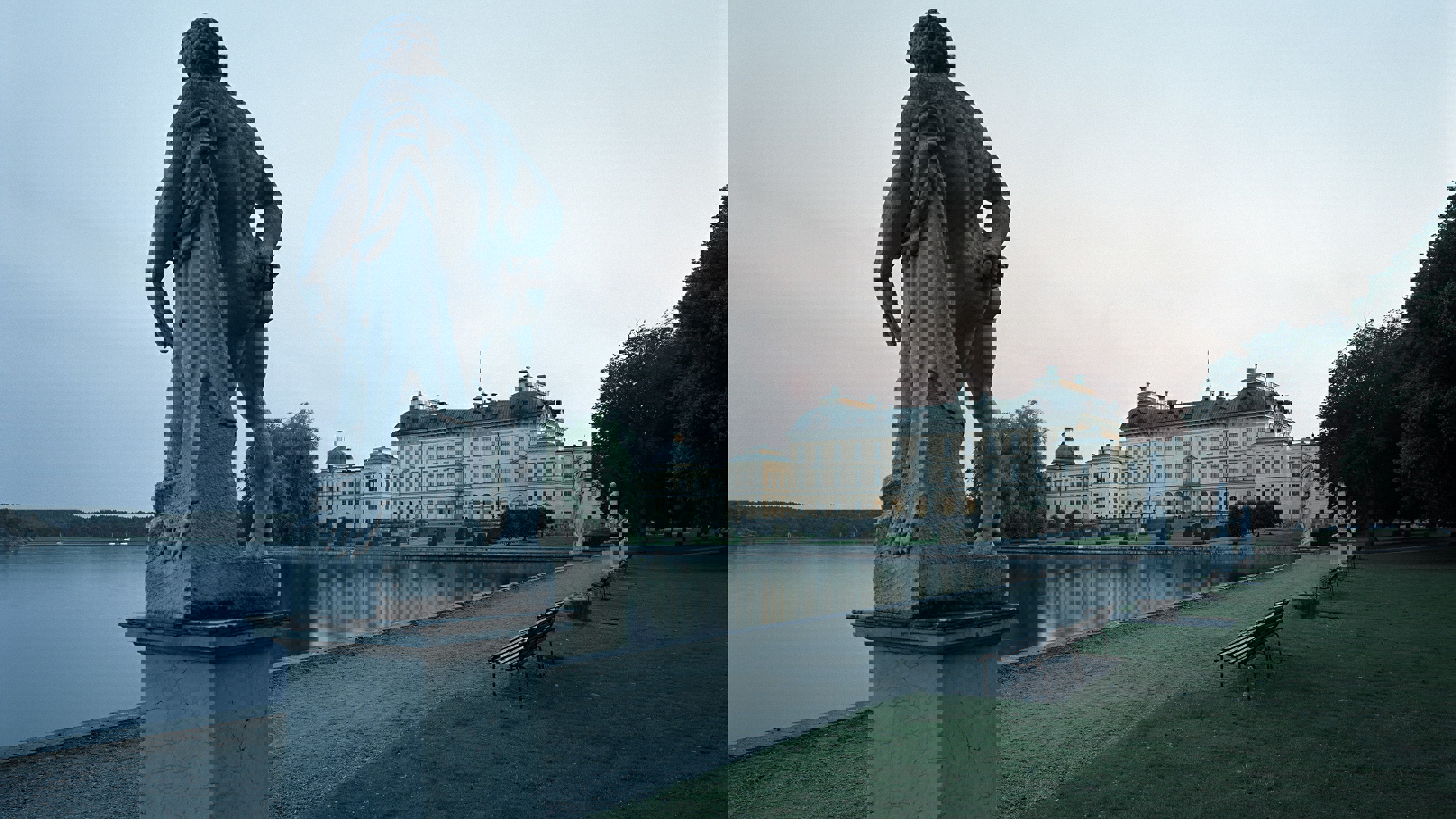 Drottningholms slott i skymningen med en skulptur i förgrunden.